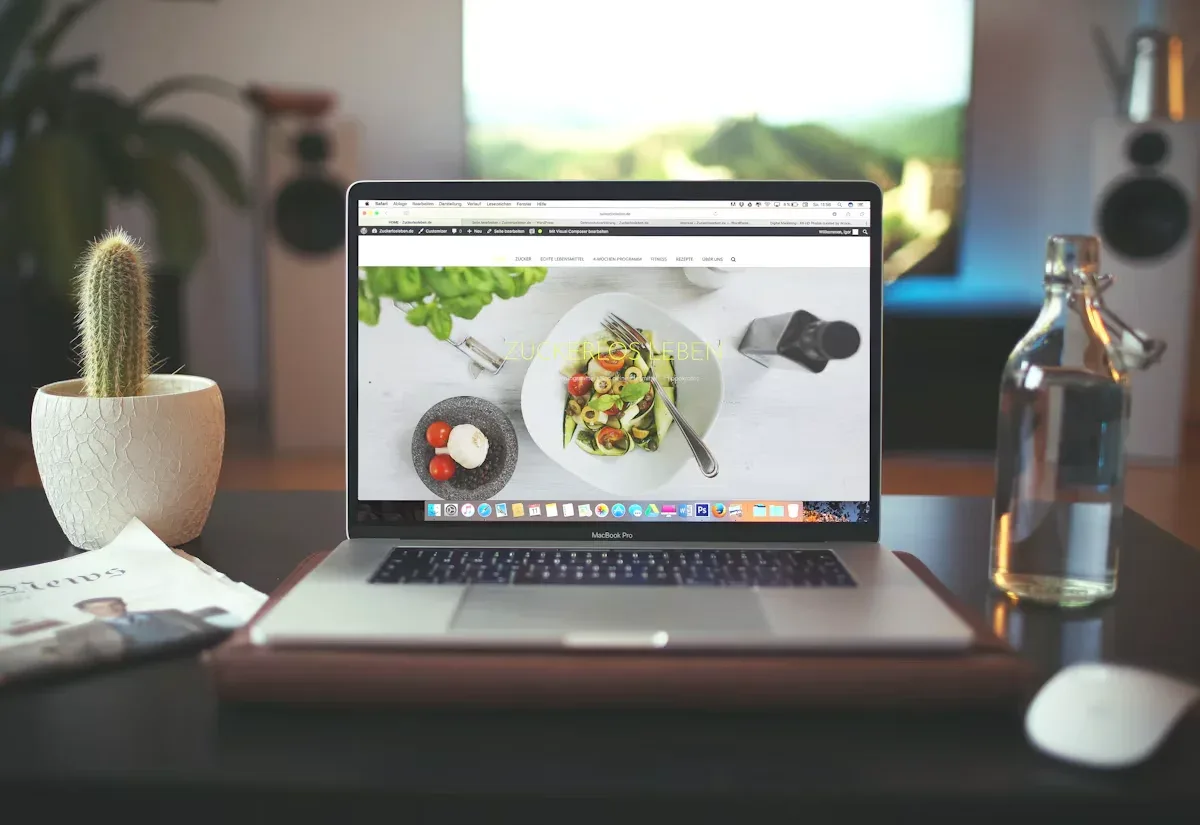 Restaurant website open on a laptop showing a plated dish