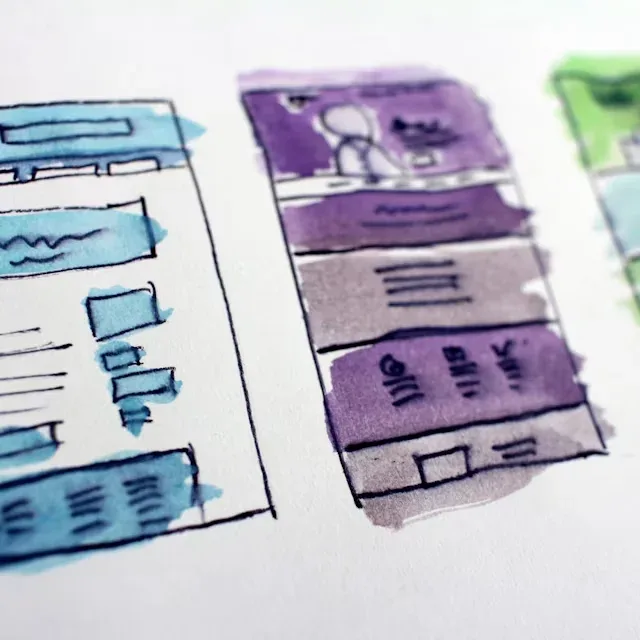 Hand-drawn wireframe sketches of website page layouts