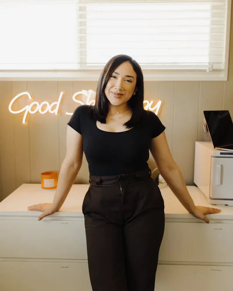 Small business owner standing behind the counter of her shop